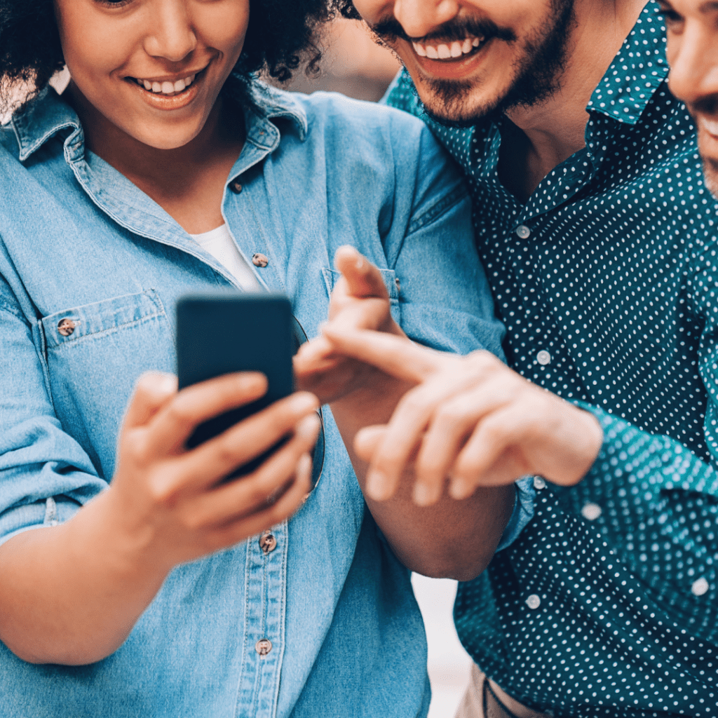 patients gathered around a phone to engage with their pharmacy on social media