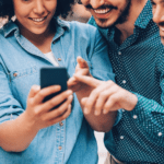 patients gathered around a phone to engage with their pharmacy on social media
